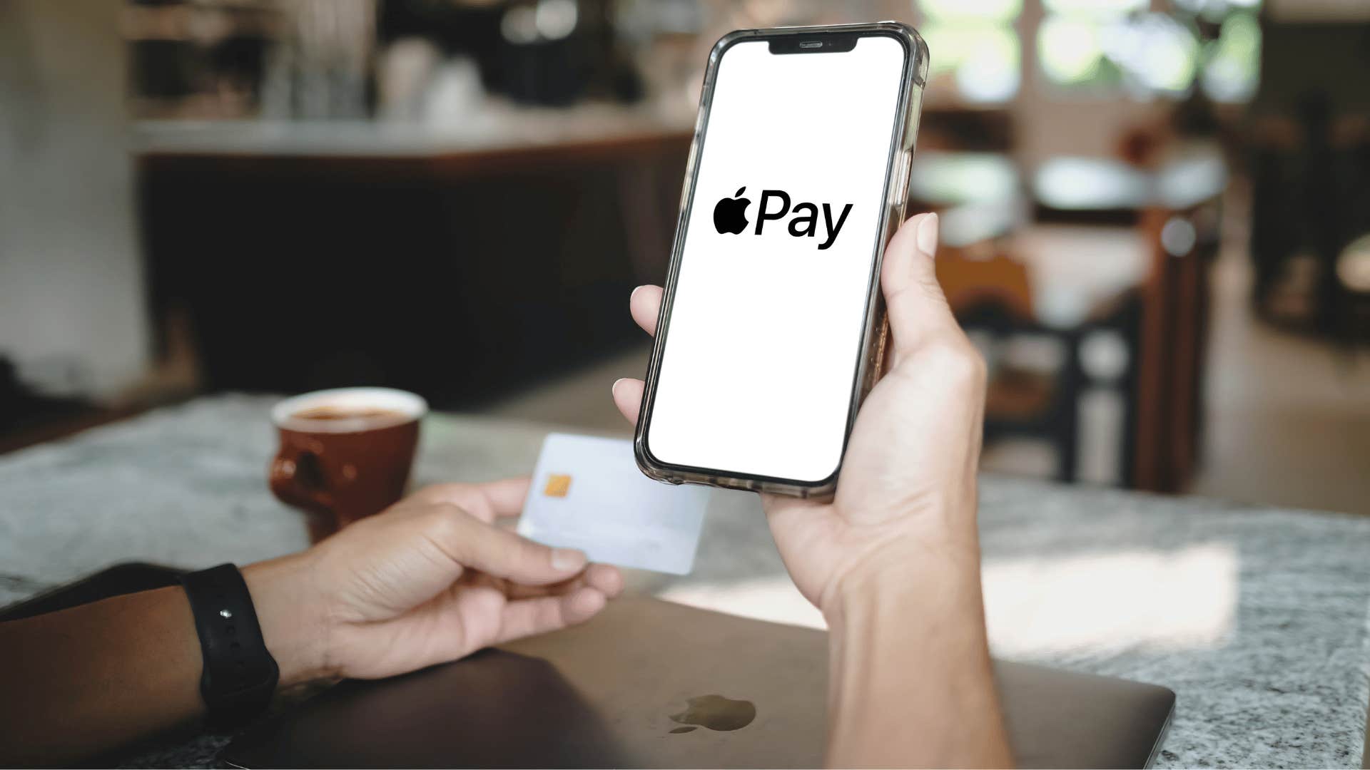 man using apple pay for everything as he sits at cafe
