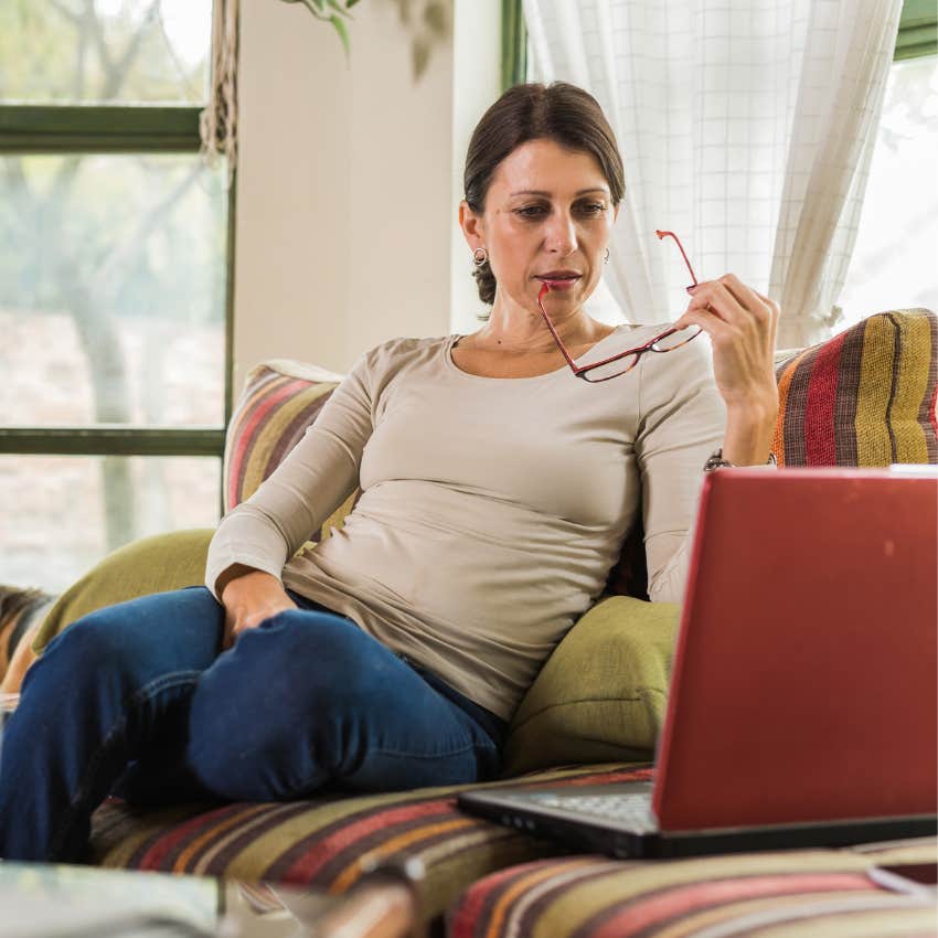 woman working on her computer while sitting on the couch almost always gets what she wants because she's willing to struggle