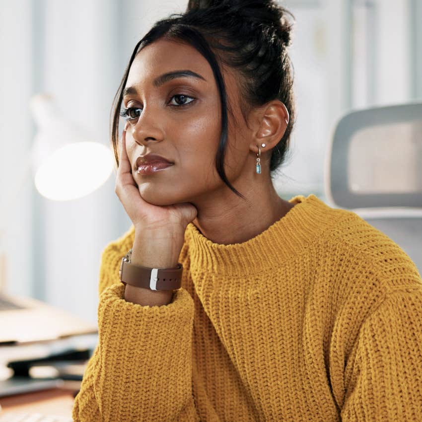 high-IQ woman at work overthinking everything at her desk