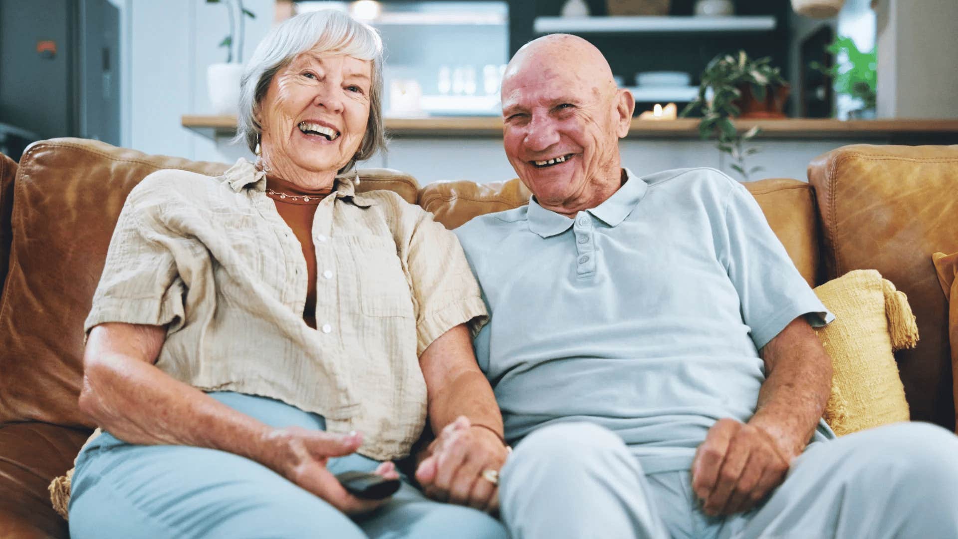 older couple on the couch watching cable tv