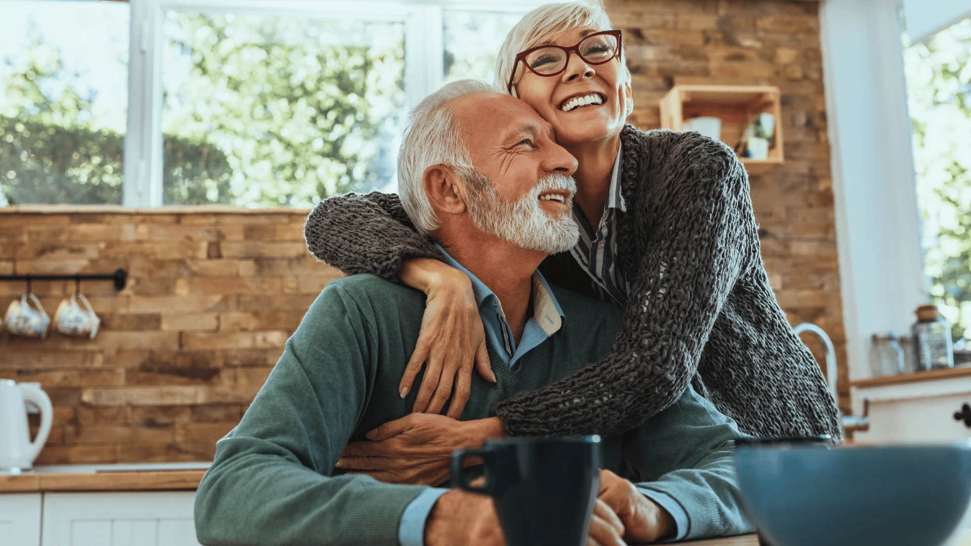 boomer couple smiling in their owned home