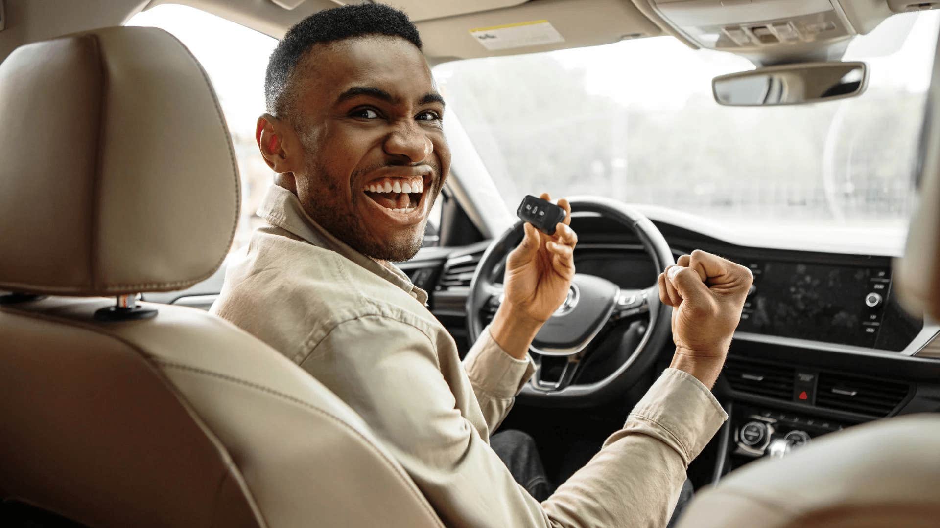 gen X man driving a new luxury car