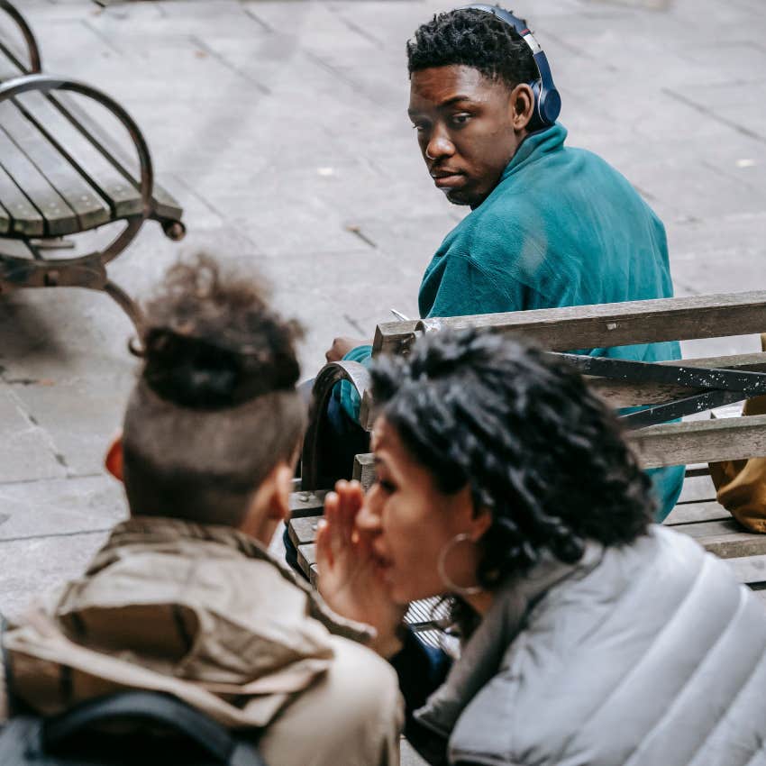 intelligent man witnessing people gossiping but not offering his opinion