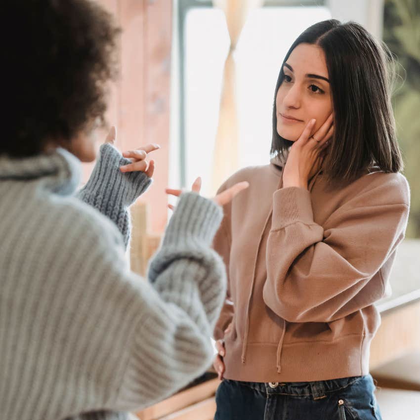 intelligent woman avoiding giving her two cents to friend who is misunderstanding