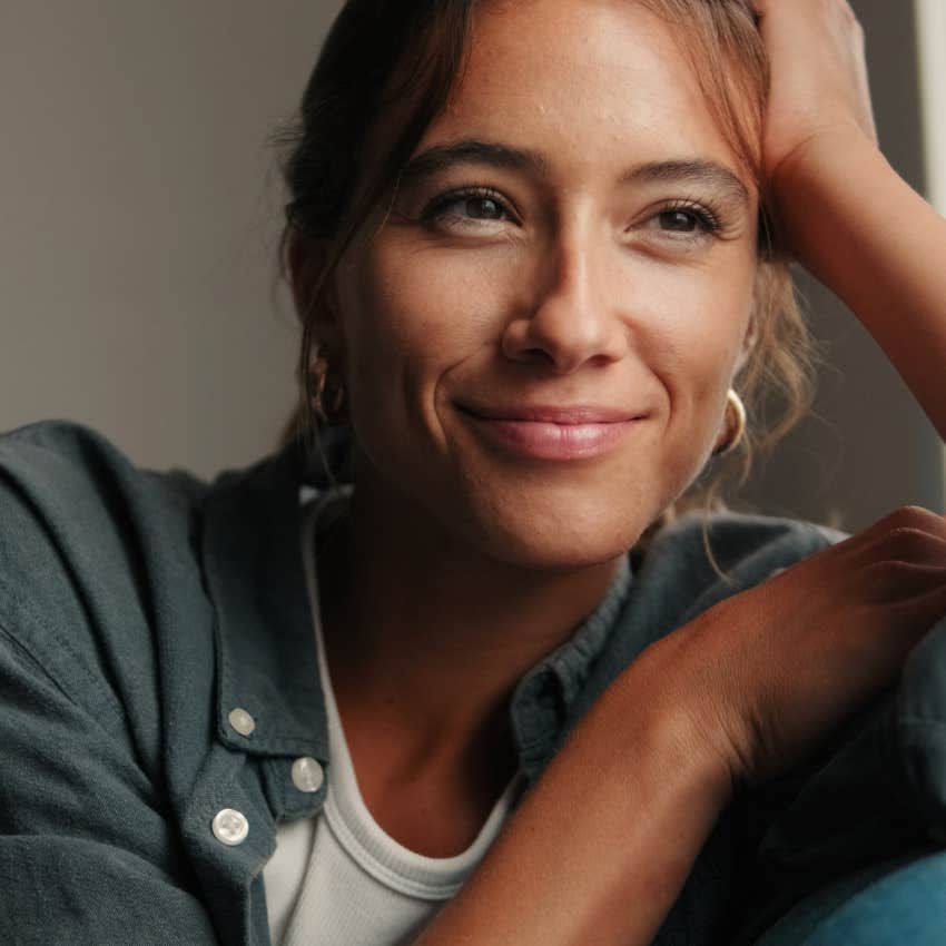smiling woman letting go of things she can't control