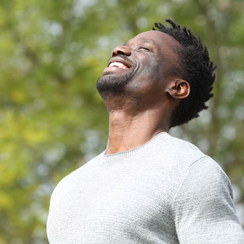 happy man sending good into the world meditating outside