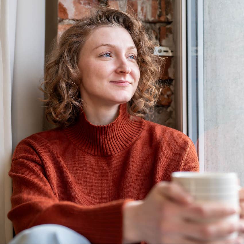 happy woman drinking coffee speaking kindly to herself
