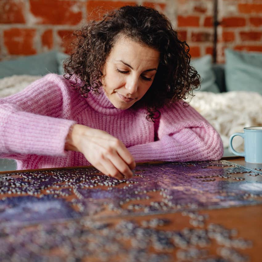 neurodivergent woman solving a puzzle deep in thought