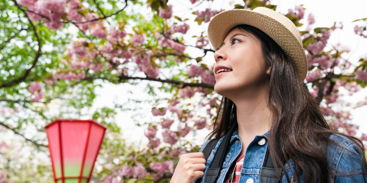 woman surrounded by cherry blossoms