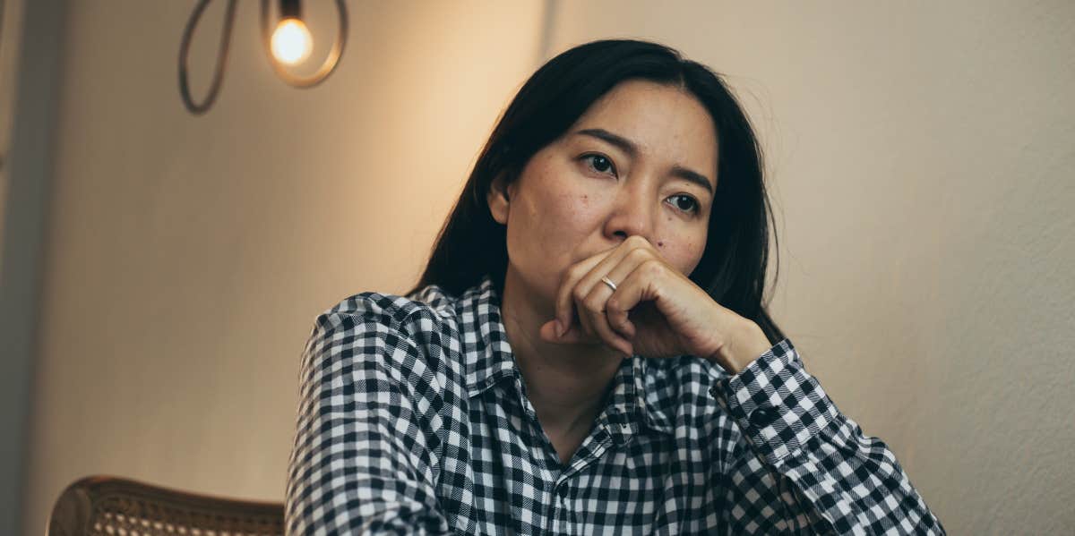 sad woman alone at table