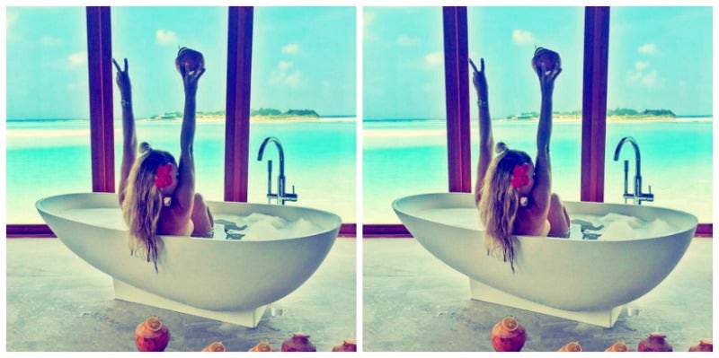 woman soaking in bath with roses 