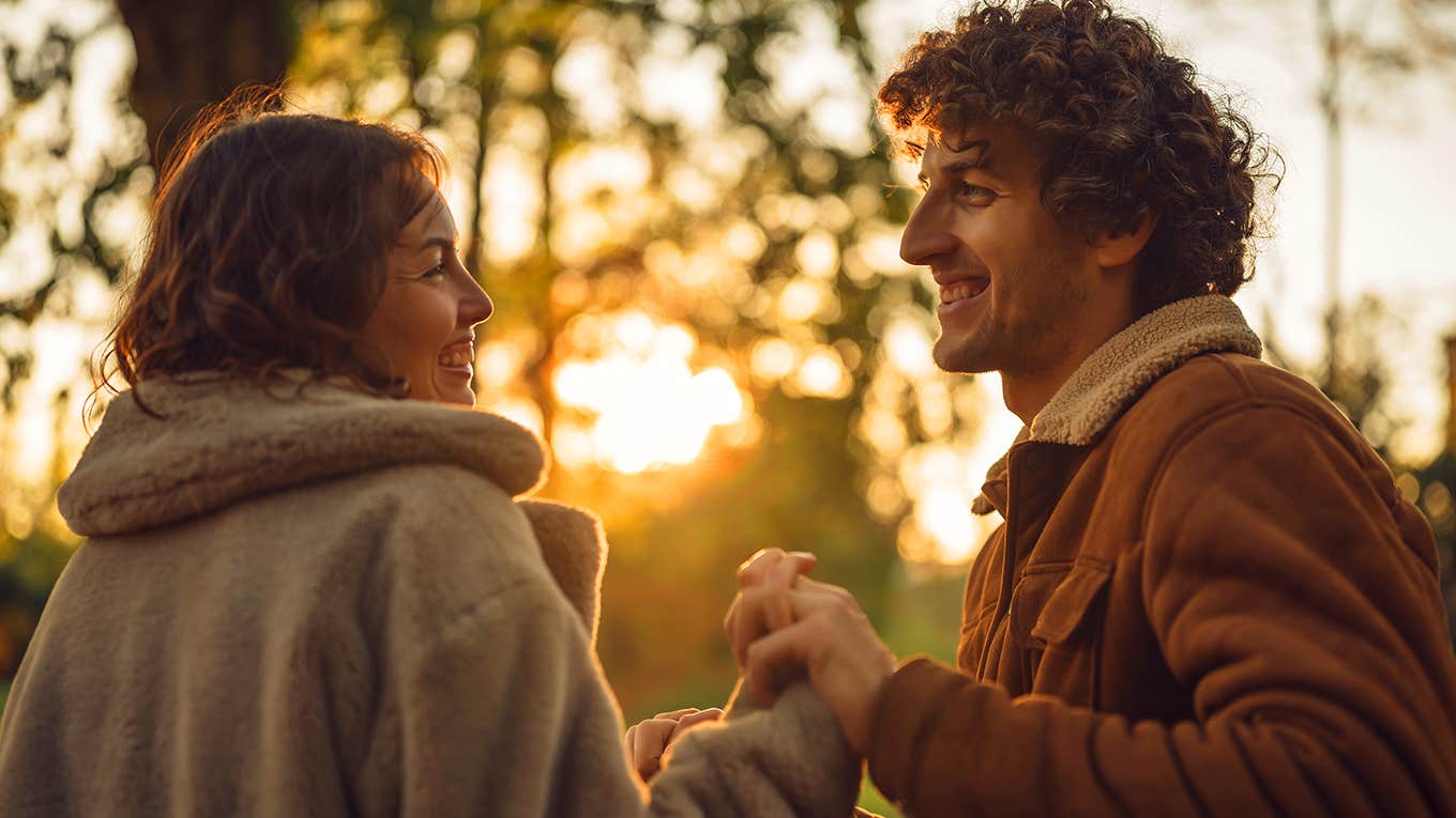 couple holding hands at sunset