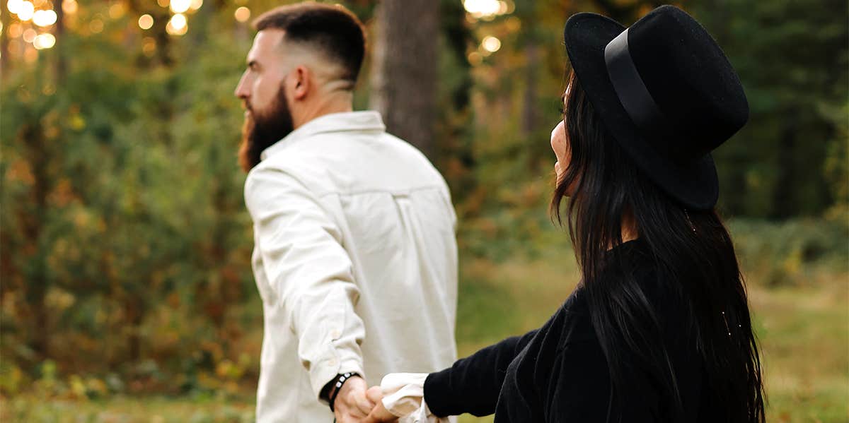 man and woman walking holding hands