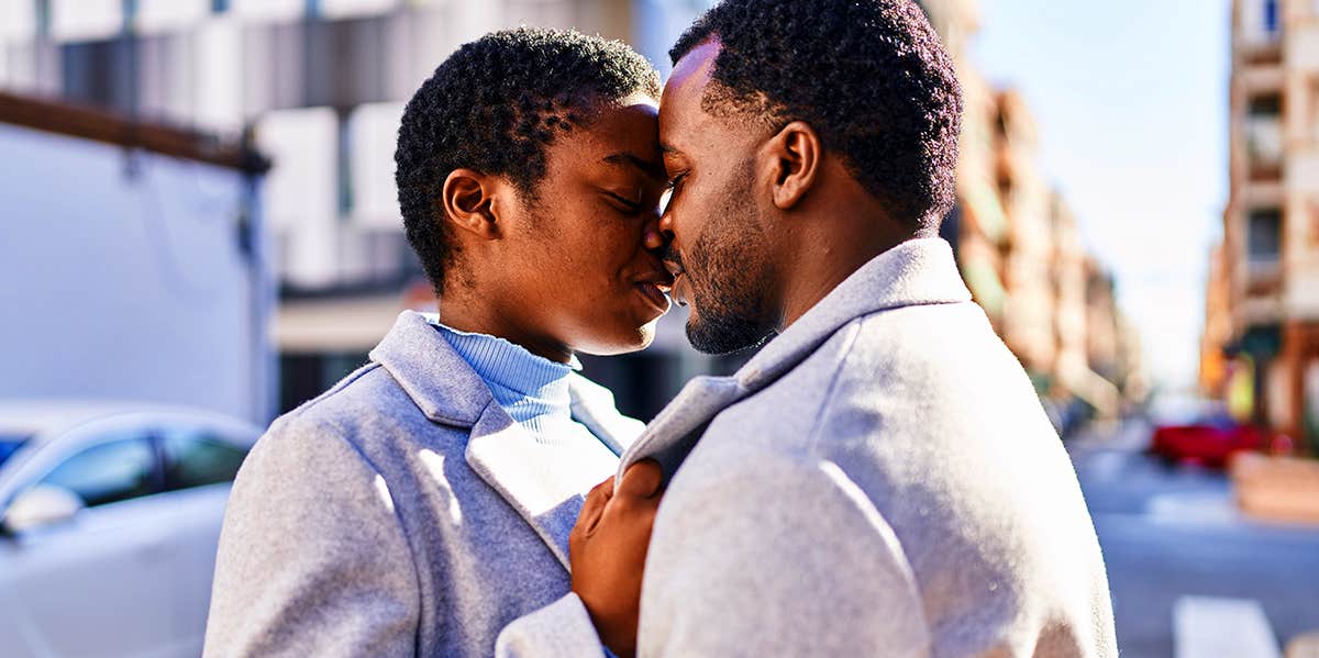 man and woman kissing in street