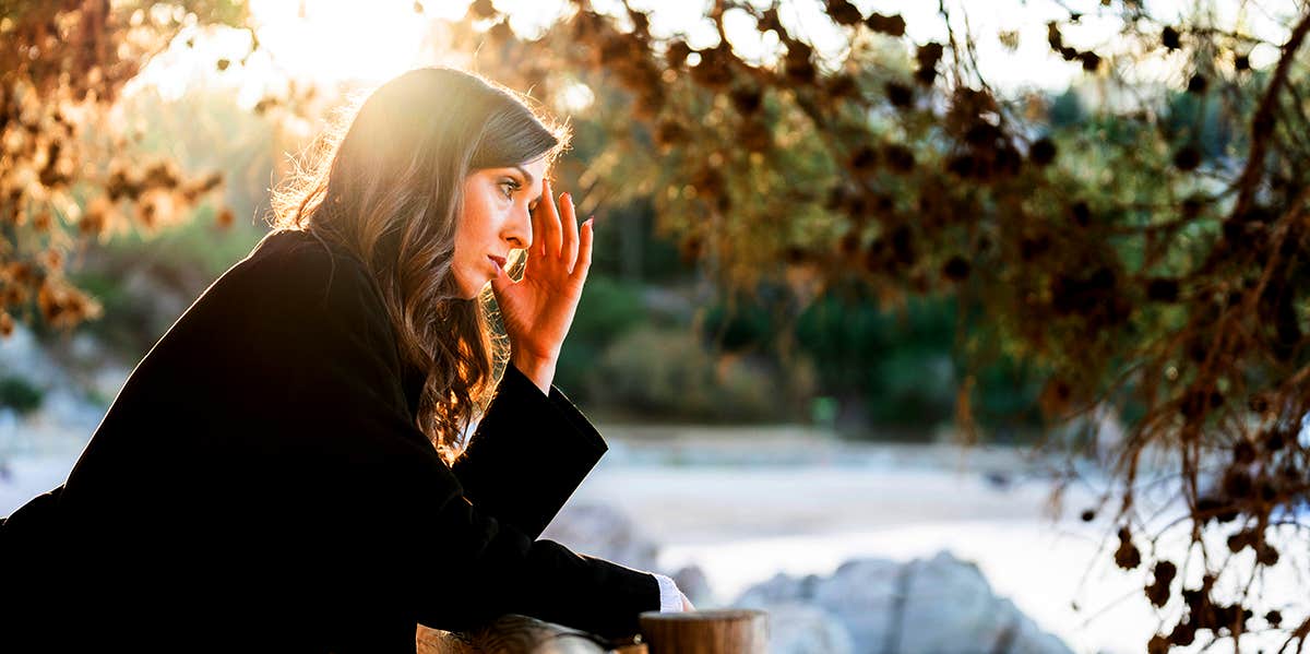 woman standing outside thinking