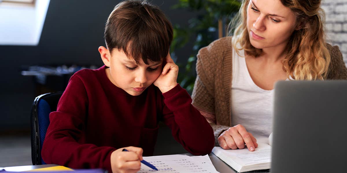 boy doing homework with tutor