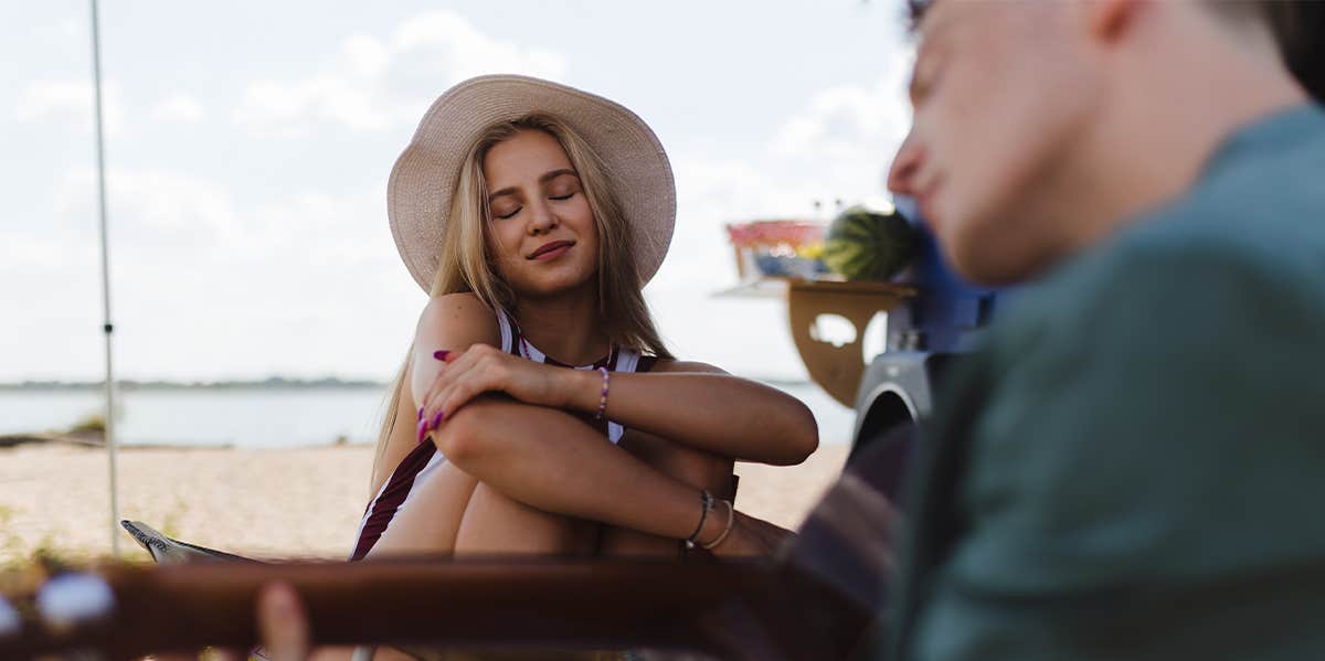 man and woman sitting at the beach