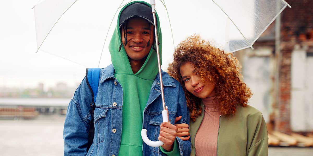 couple walking in the rain with umbrella