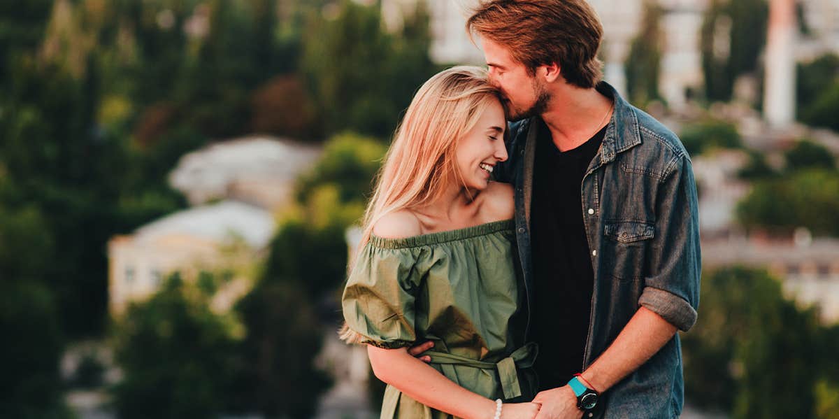 guy kissing girl on head