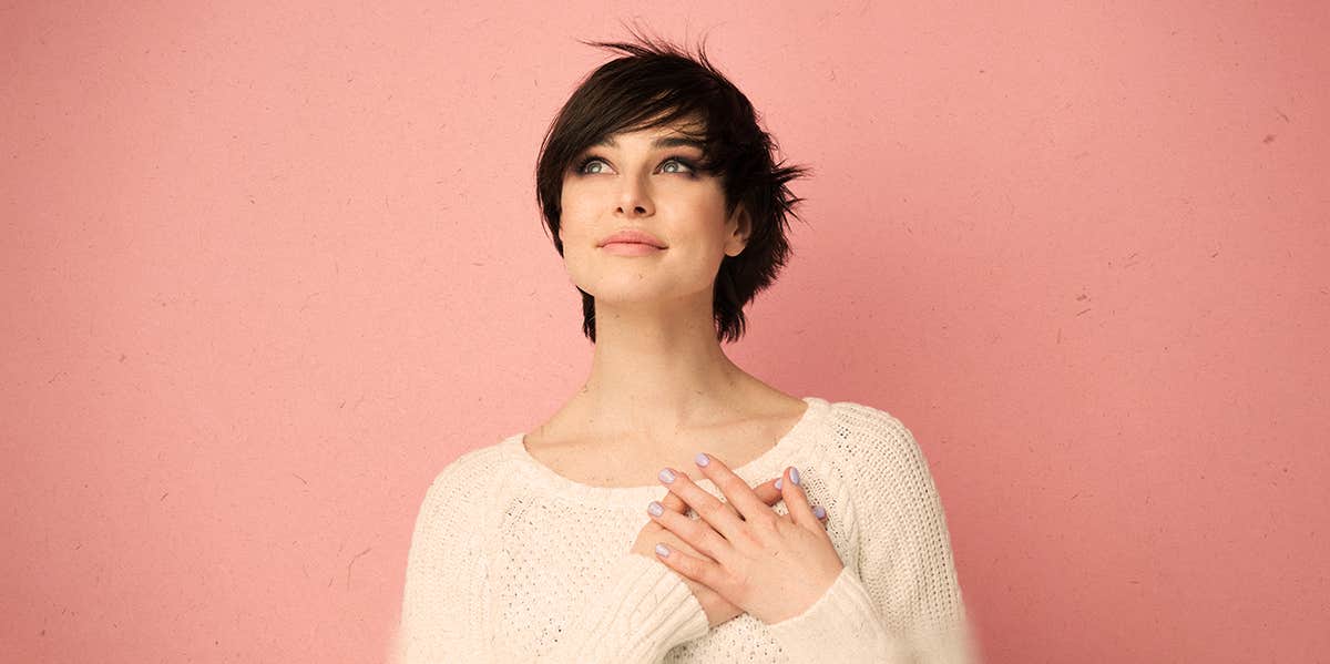 4 Ways To Stop Taking Things So Personally woman holding her hands against her heart