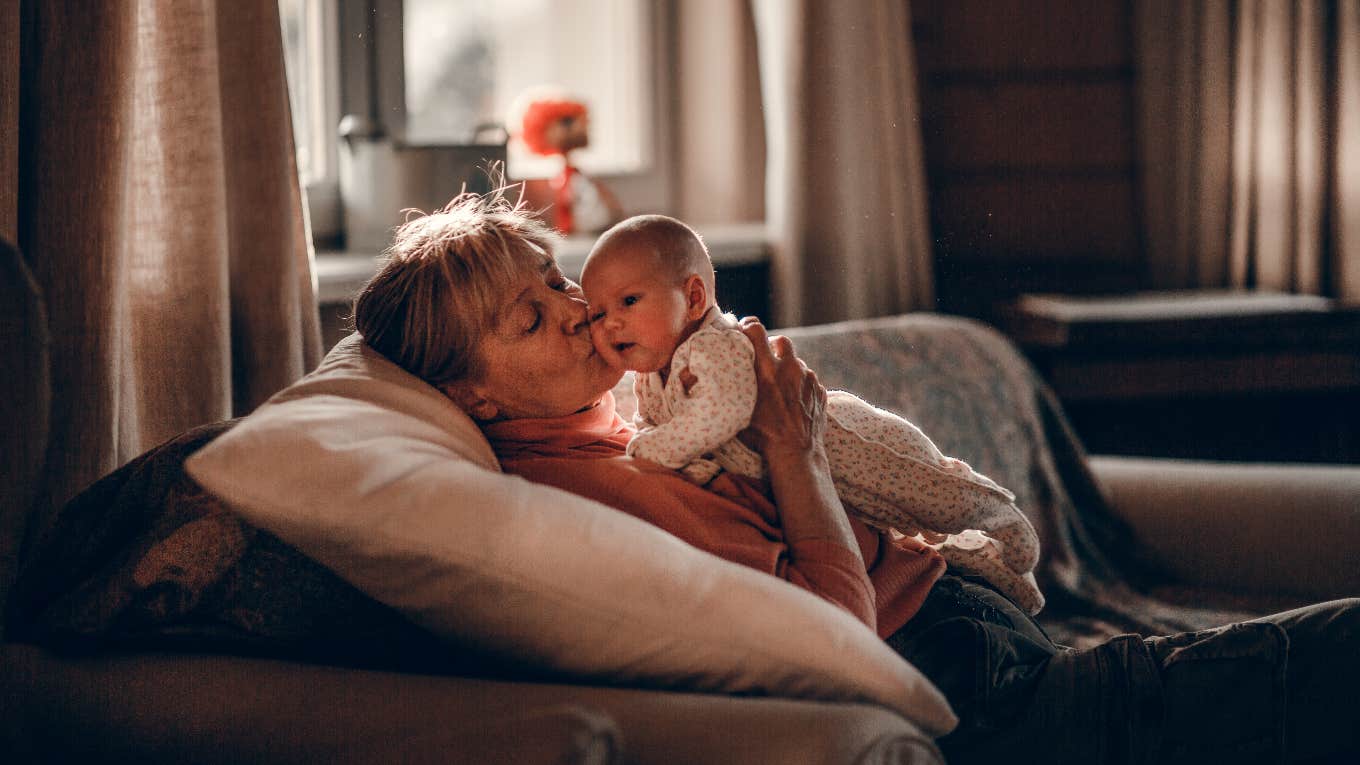 older woman holding a baby