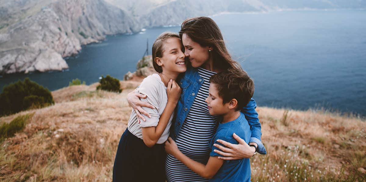 mother hugging children