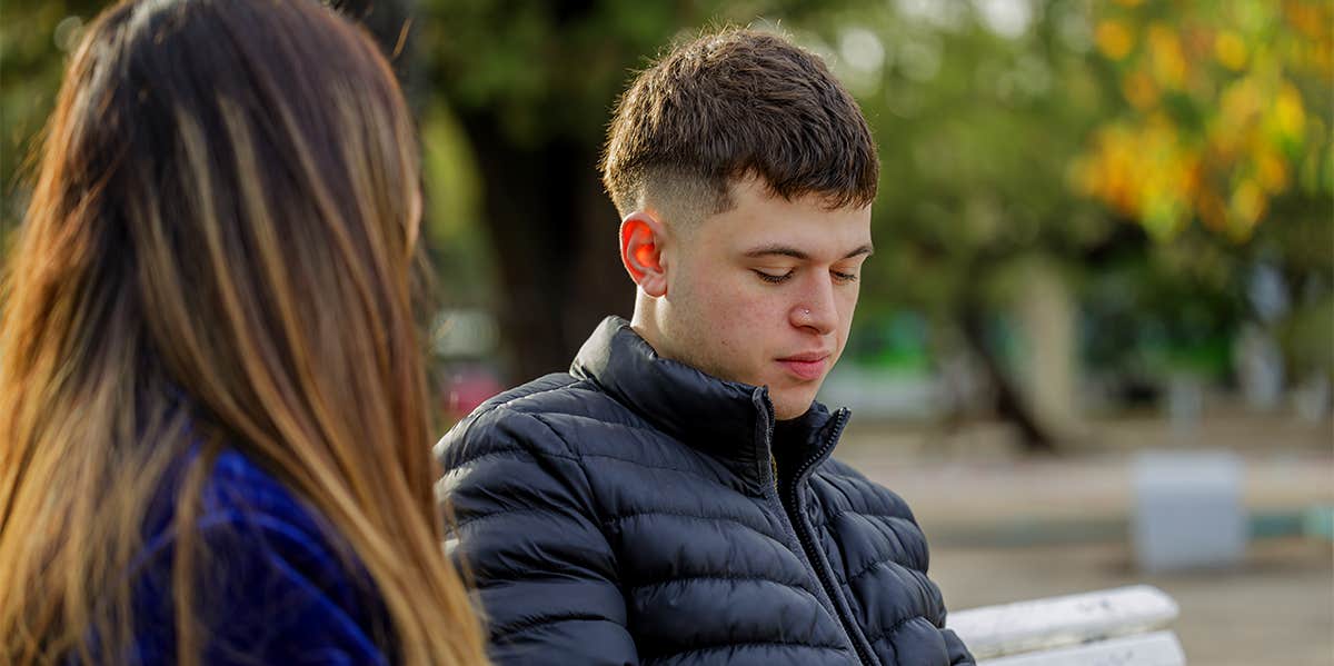 girl talking to guy on bench