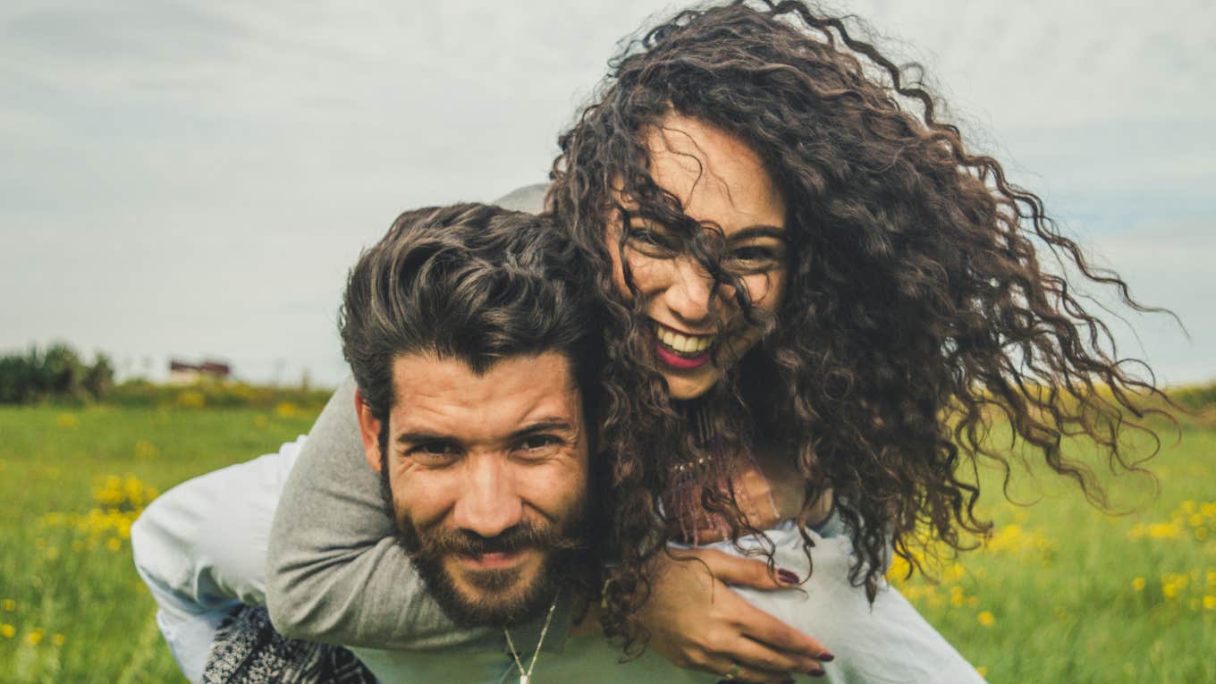 5 Days To Schedule With Your Partner Every Month To Make Sure Your Relationship Actually Lasts man and woman smiling and embracing