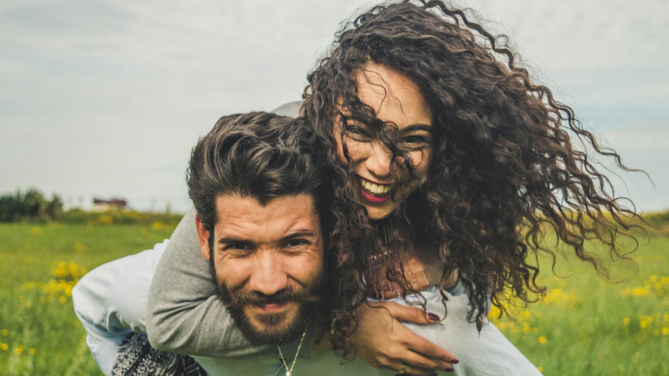 man and woman smiling and embracing