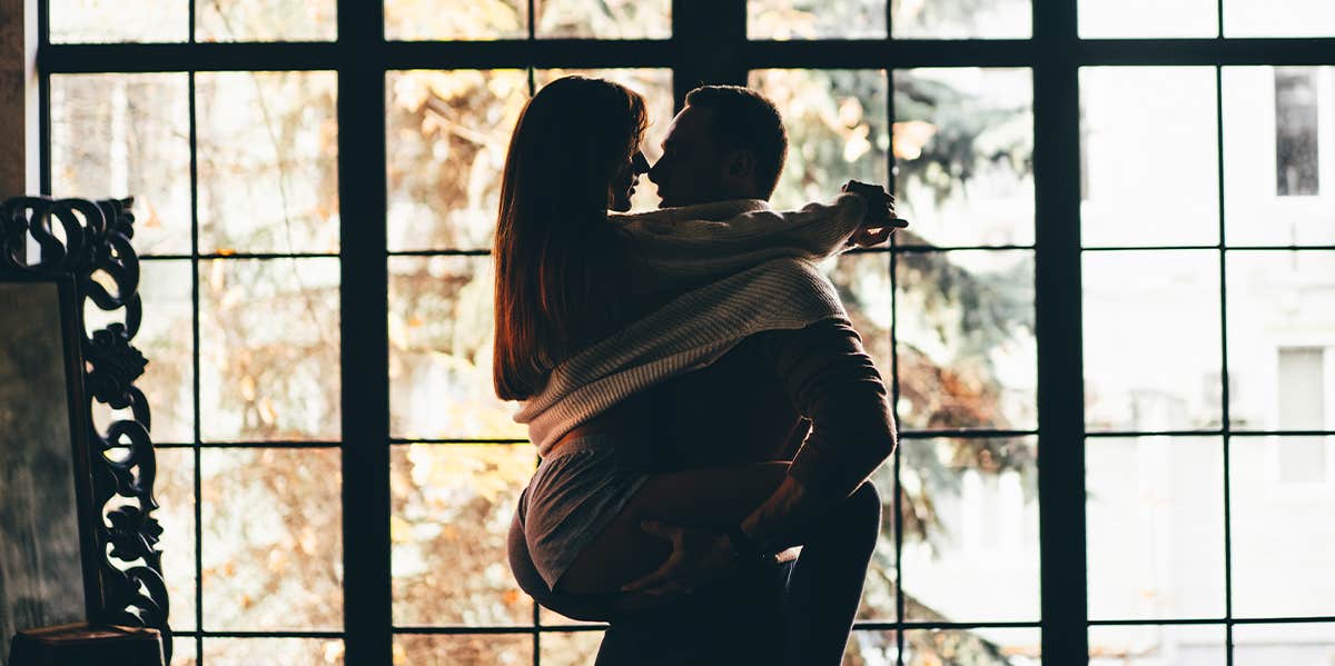 man carrying woman cuddling