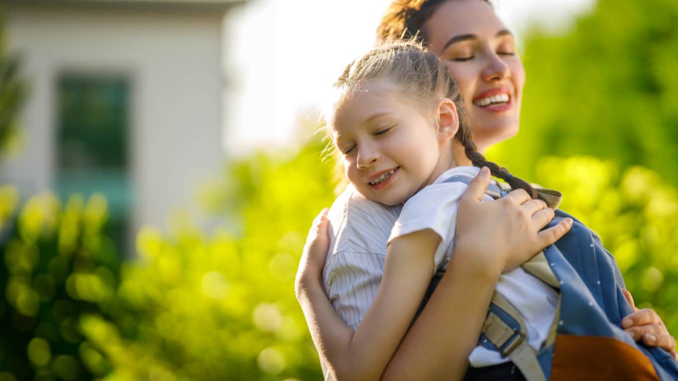 mother and daughter hug before going to school