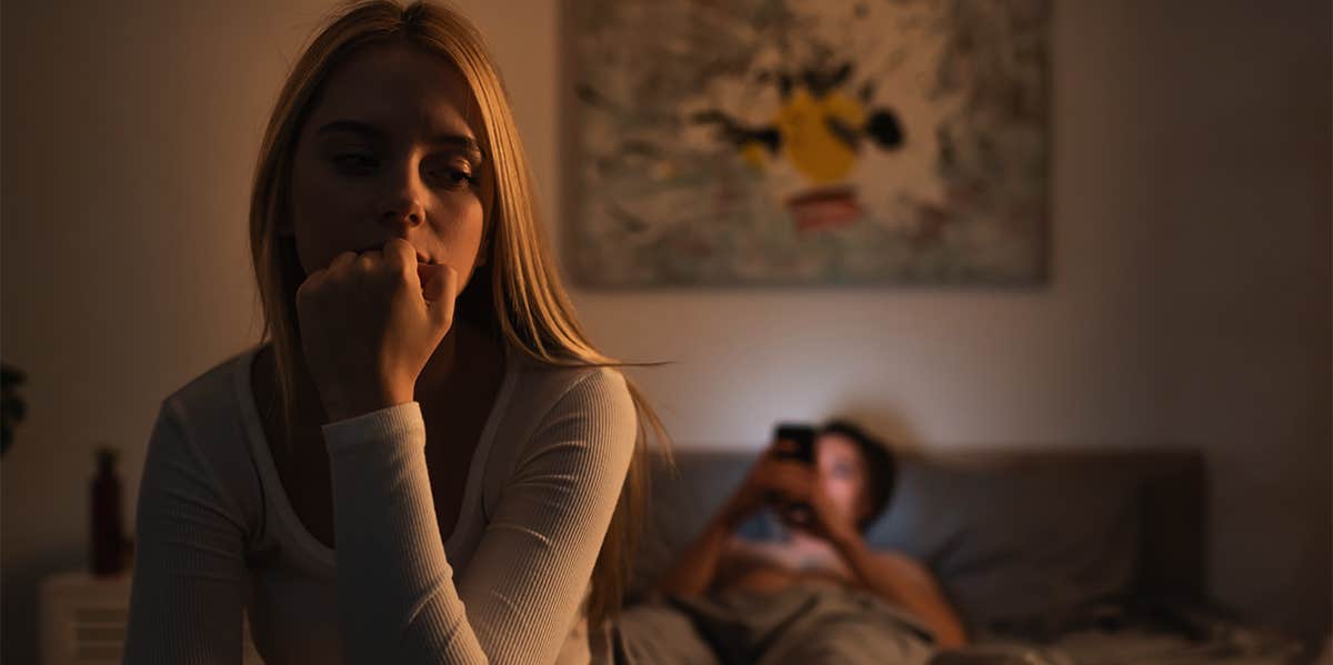 Insecurities You Project Onto Your Man (That Turn Him Off) unhappy woman sitting in bedroom