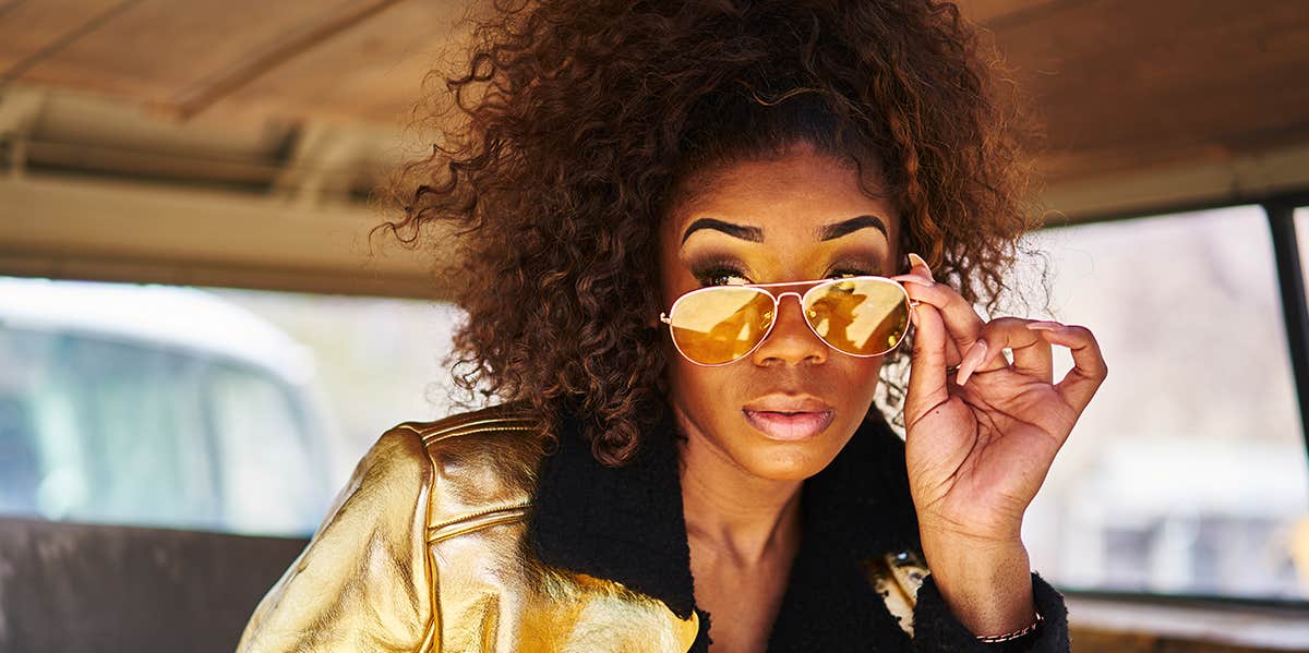 6 Things Women Wear That Turn Men Off girl pulling down sunglasses