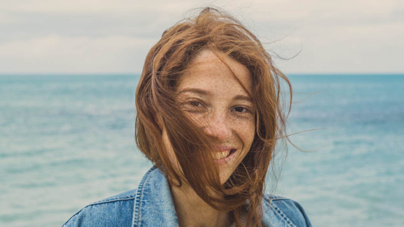 woman smiling by the ocean