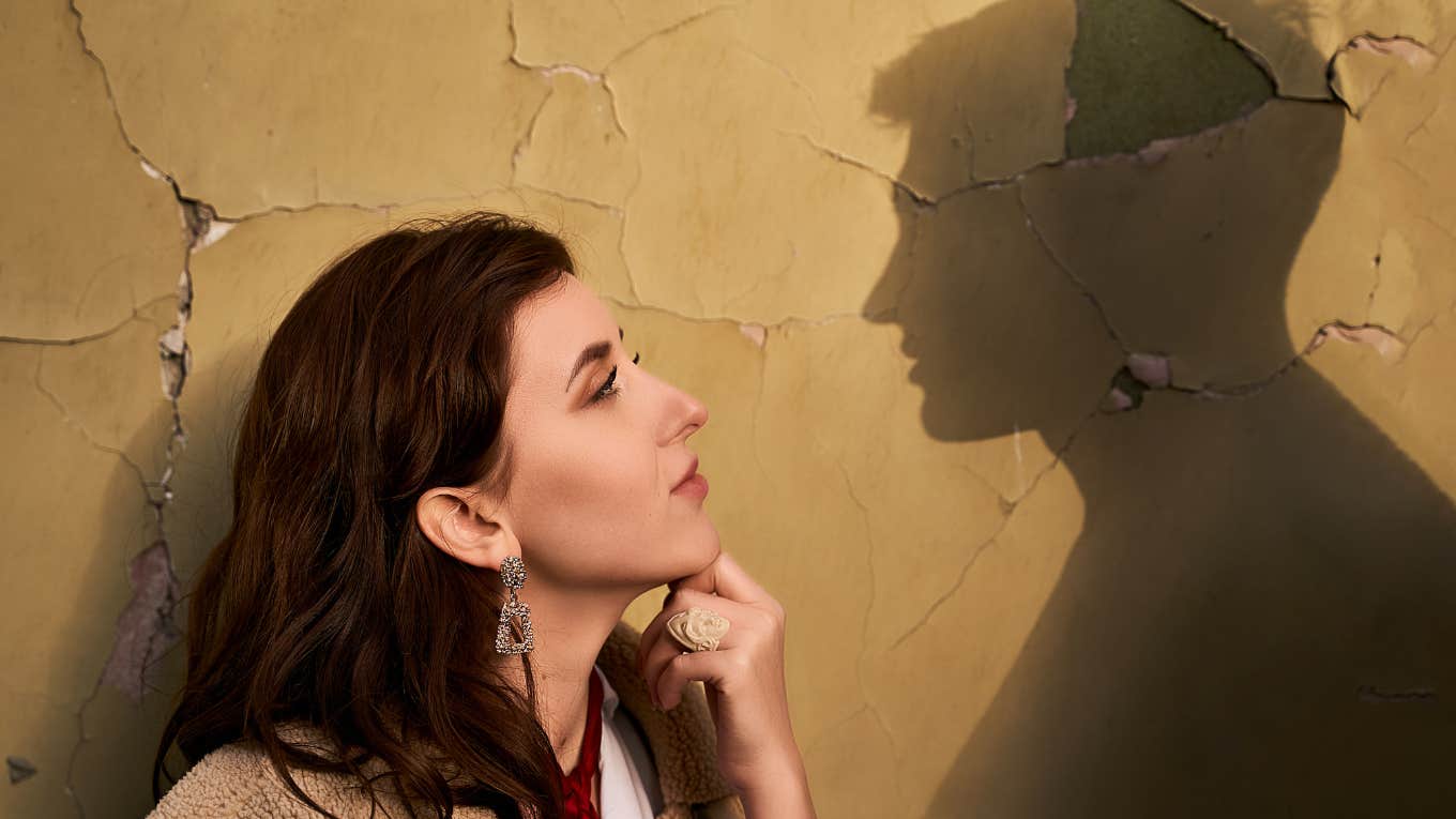 Woman looking at mans shadow 