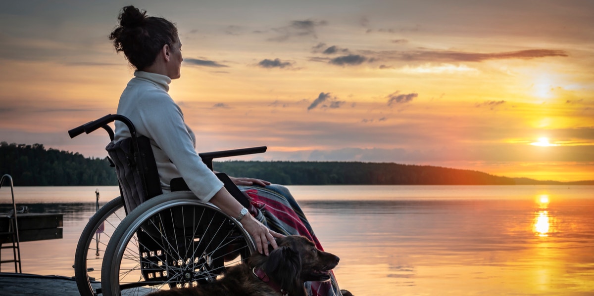 woman in wheelchair looking at sunset