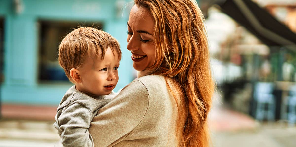 mom carrying toddler son