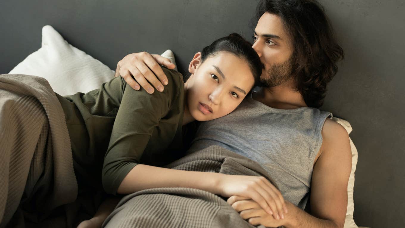 a couple lying in bed together