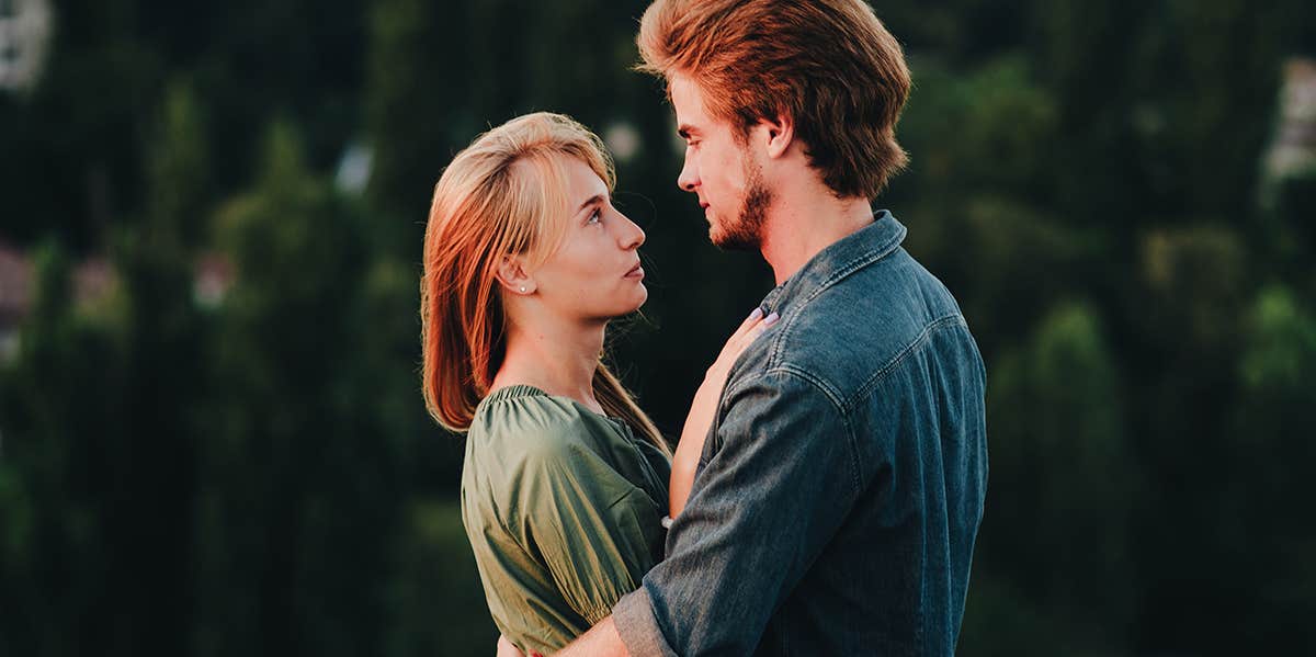 man and woman hugging looking at each other