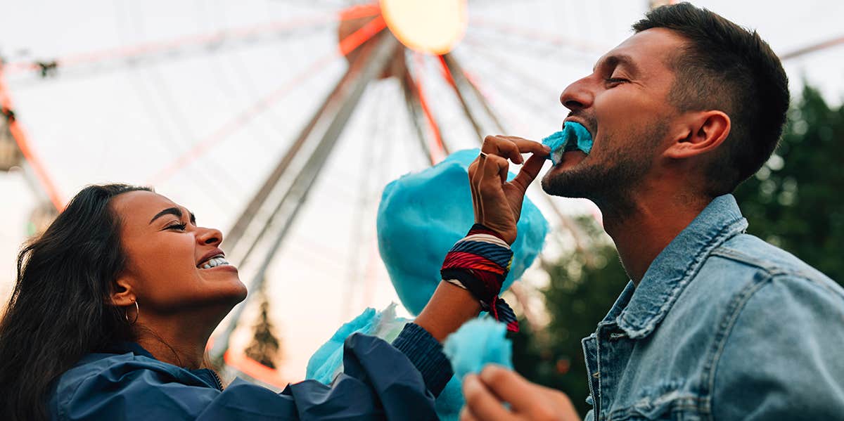 girl feeding boyfriend cotton candy