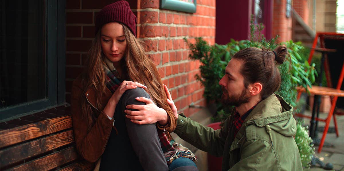 unhappy woman with boyfriend asking for forgiveness