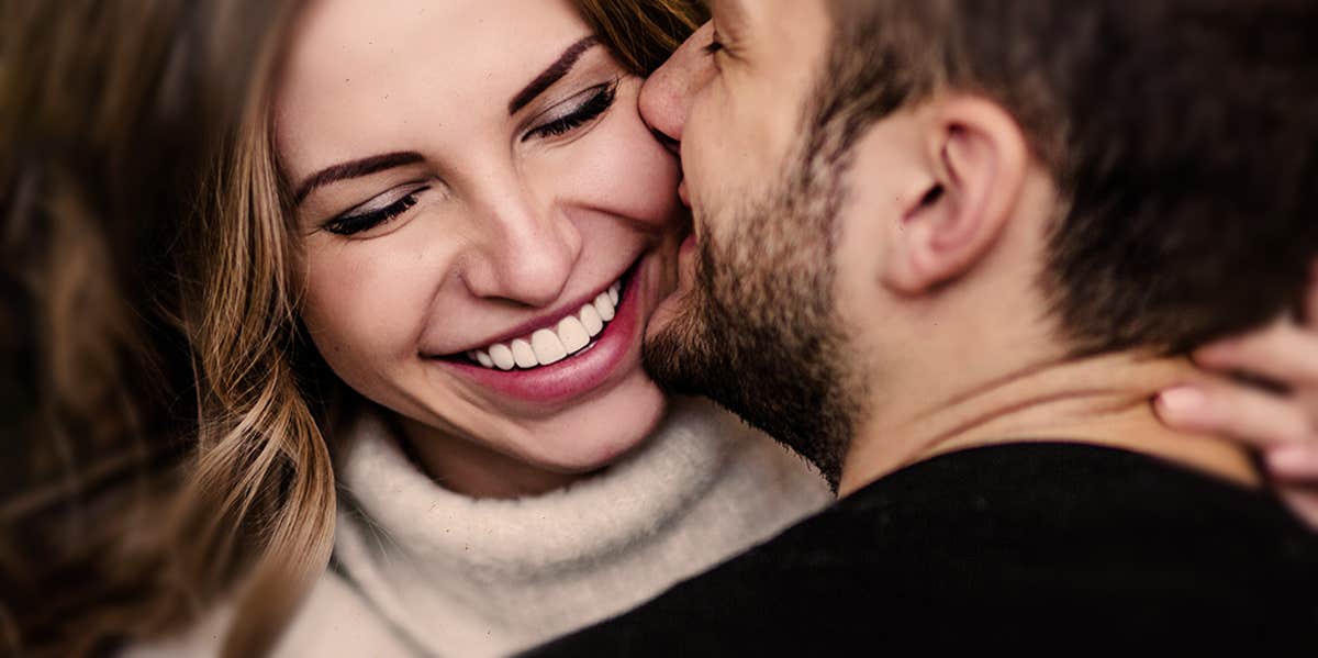 man and woman hugging and kissing one another