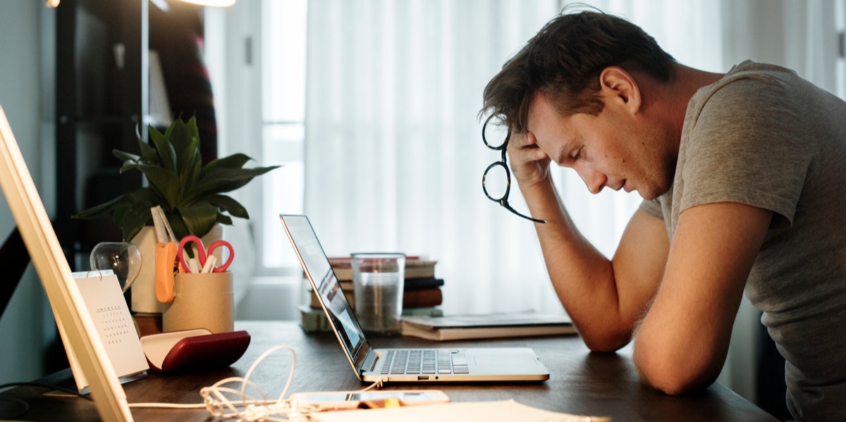 man stressed at desk working