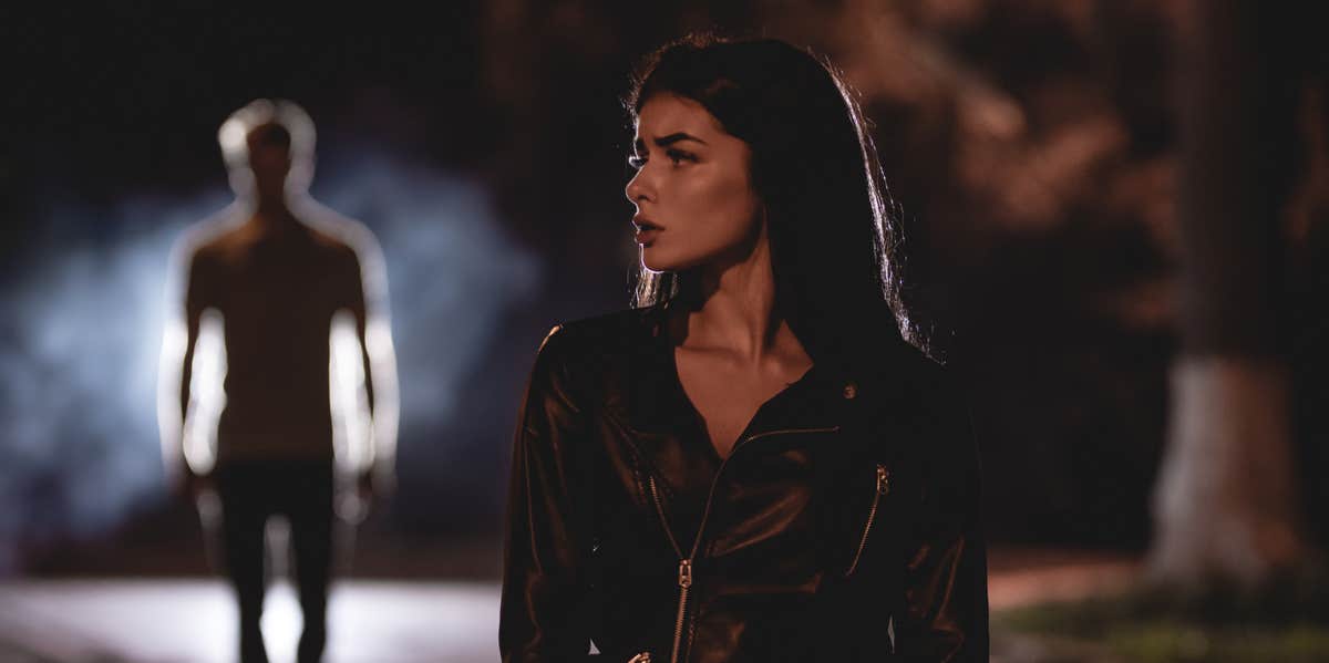 5 Signs He's A Stalker (And It Goes Beyond Normal 'Interest' In You) man stalking woman