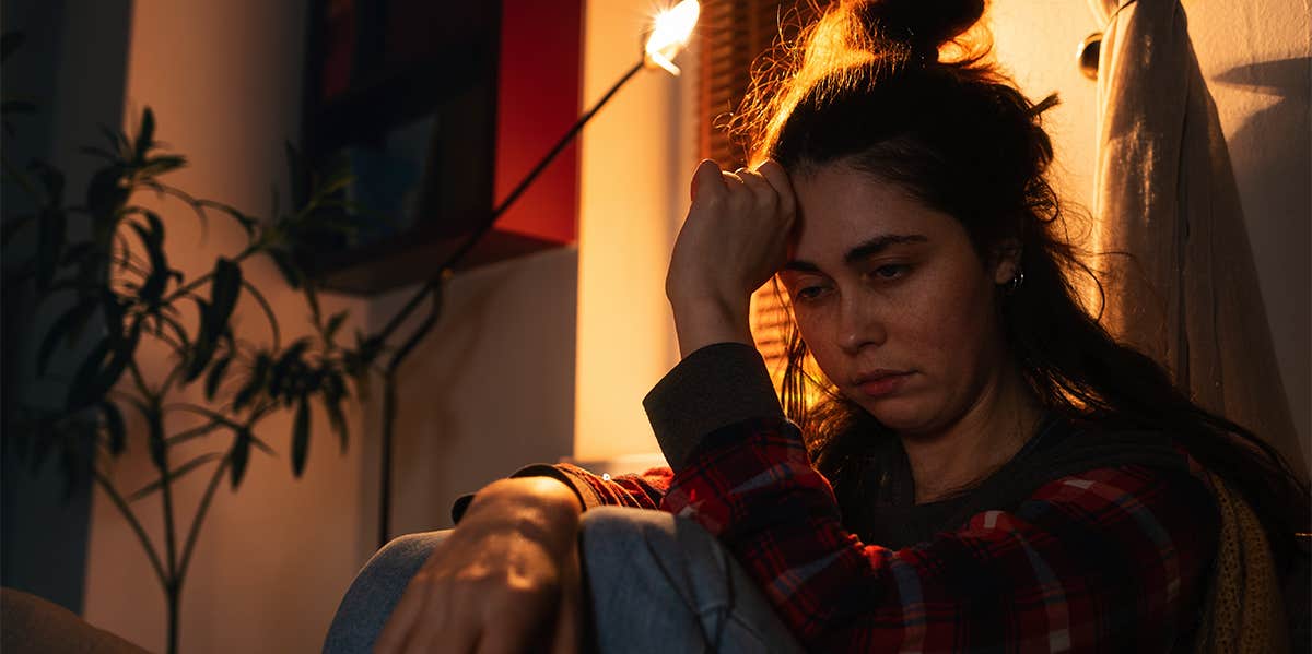 woman sitting alone in bedroom