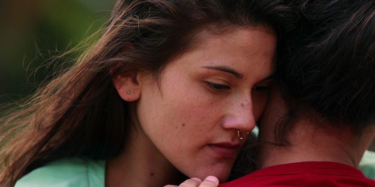 girl hugging partner unhappy