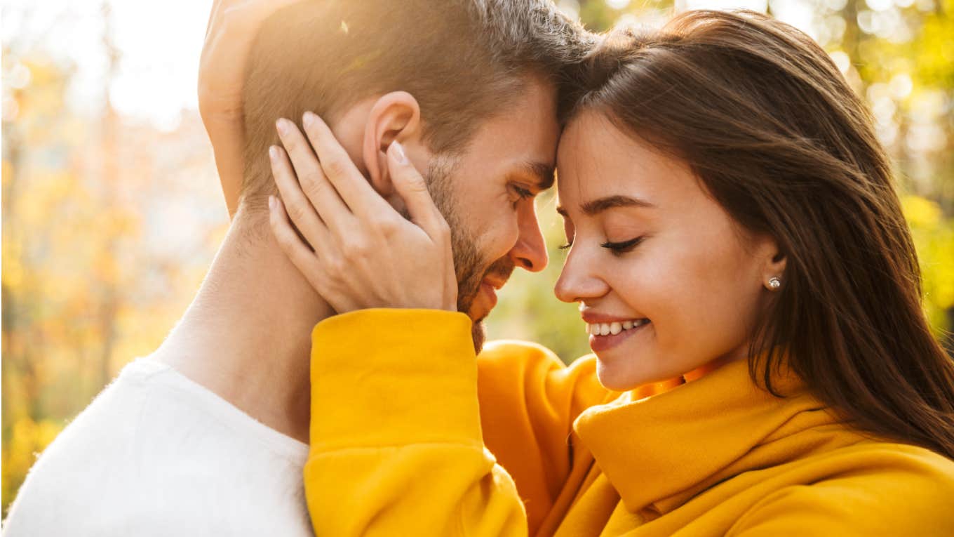 man and woman embrace each other outside