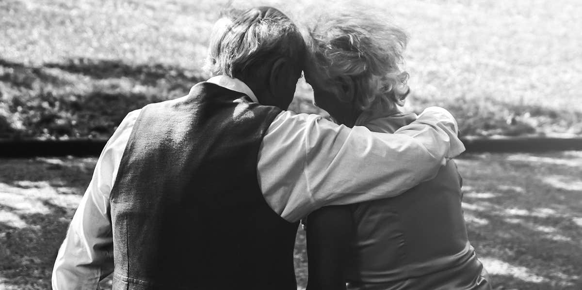 elderly couple hugging