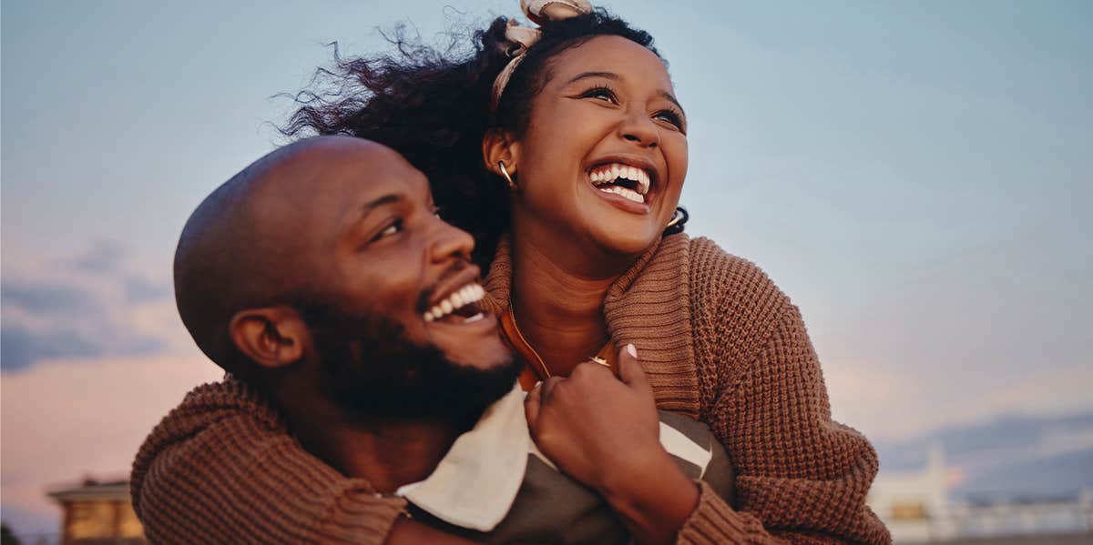 woman hugging man on the beach