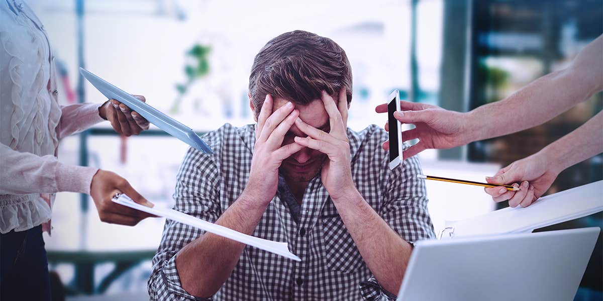 stressed man overwhelmed with work